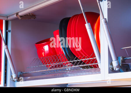 open kitchen shelf with colorful dishes, closeup Stock Photo