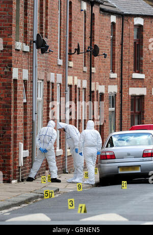 Police at the scene in Shildon, County Durham where a man was shot the previous night. Stock Photo