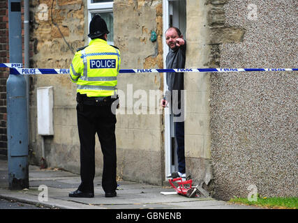 Shildon shooting. A neighbour talks to police at the scene in Shildon, County Durham where a man was shot last night. Stock Photo