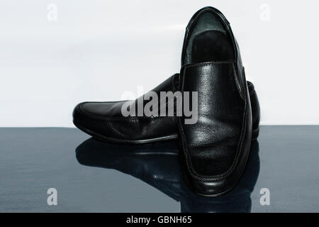 Men black leather shoes isolated on a white and gray background Stock Photo