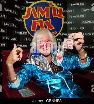 Sir Jimmy Savile is reunited with his famous Jim'll Fix It chair which is on display at Savile Hall, Leeds. Jimmy Savile is known as the first and last presenter off the popular BBC music show, 'Top of the Pops', and his long running show 'Jim'll Fix It' as well as being one of the first DJ's on Radio Luxembourg in the 1950's and 1960's and then Radio One in 1968. Stock Photo