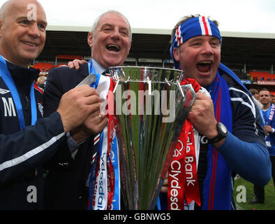 (left to right) Rangers coach Kenny McDowall, manager Walter Smith and assistant manager Ally McCoist celebrate with the trophy Stock Photo