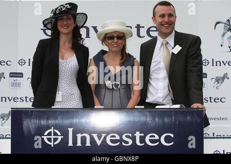 Former Apprentice candidates's Debra Barr (left), Lorraine Tighe (centre) and James McQuillan (right) during Derby Day at Epsom Downs Racecourse Stock Photo