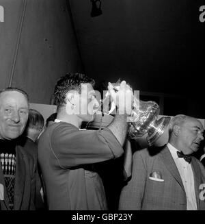Manchester United captain Noel Cantwell guzzles milk from the FA Cup after his team's 3-1 win Stock Photo