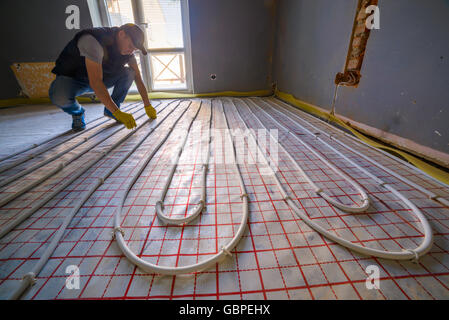 pipefitter installing system of heating Stock Photo