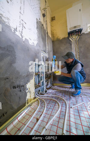 pipefitter installing system of heating Stock Photo