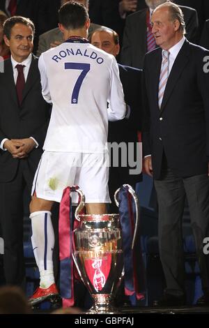 Manchester United's Cristiano Ronaldo is consoled by Italian Prime Minister Silvio Berlusconi (centre), Spanish President Jose Luis Rodriguez Zapatero (left) and King Juan Carlos of Spain as he receives his runners up medal. Stock Photo