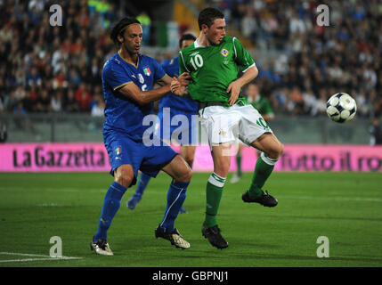 Italy's Nicola Legrottaglie and Northern Ireland's Corry Evans in action during the International Friendly at the Arena Garibaldi Stadium, Pisa, Italy. Stock Photo