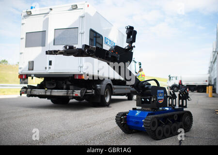 Munich, Germany. 04th July, 2016. The Federal Police radio-control manipulator from the defuser can be seen at the airport in Munich, Germany, 04 July 2016. Using a radio-control manipulator, also known as a 'bomb robot, ' the defuser can get closer to a dangerous object, inspect it, and destroy or defuse it without risking his or her own life. The 'tEODor' robot from 'telerob' can be expanded with numerous instruments and tools. Photo: MATTHIAS BALK/dpa/Alamy Live News Stock Photo