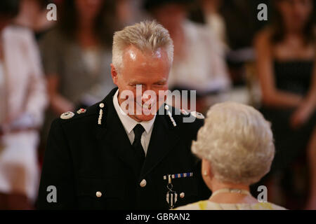 Mr. Stephen Otter, Chief Constable of Devon and Cornwall Constabulary, is decorated with The Queen's Police Medal by Queen Elizabeth II at Buckingham Palace. Stock Photo