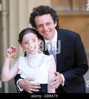 Actor Michael Sheen and daughter Lily with the OBE he received earlier from Queen Elizabeth II during investitures at Buckingham Palace. Stock Photo