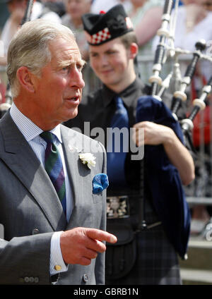 The Prince of Wales chats with members of the National Youth Pipe Band outside the National Piping Centre in Glasgow. Stock Photo