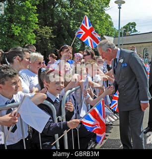 The Prince of Wales talks to children from St Barthomlemews Primary school during a visit to Castlemilk Stables in Glasgow. Stock Photo