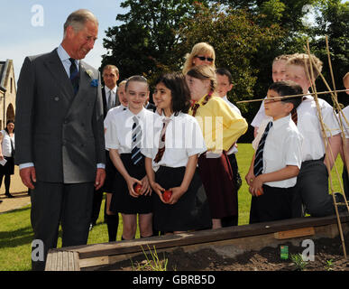 The Prince of Wales talks to pupils from Castleton primary school and St Bartholomew's primary school during a visit to Castlemilk Stables in Glasgow. Stock Photo