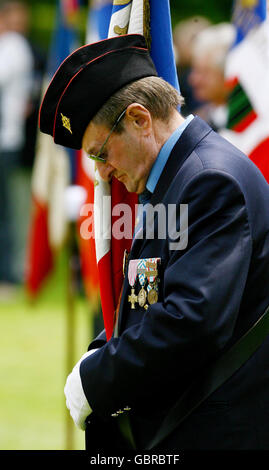 A French war veteran pays his respects during an international wreath laying ceremony at the Bayeux Military Cemetery in Normandy, France, ahead of tomorrows 65th anniversary of the D-Day landings. Stock Photo