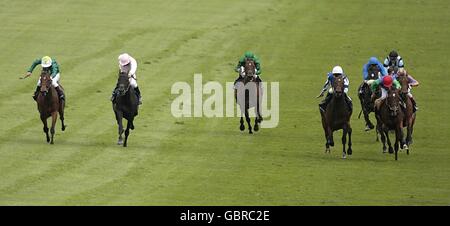 Horse Racing - The Investec Derby Festival - Ladies Day - Epsom Racecourse. Riders come down the final straight in the Investec Coronation Cup including eventual winner jockey Ryan Moore on Ask (far right) Stock Photo