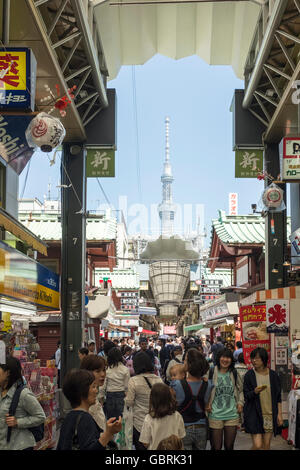 Crowds of shoppers in an arcade near Sensō-ji Buddhist temple in Asakusa with the Tokyo Skytree in the background, Tokyo, Japan. Stock Photo