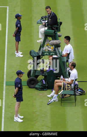 France's Julien Benneteau and Serbia's Novak Djokovic during the 2009 Wimbledon Championships at the All England Lawn Tennis and Croquet Club, Wimbledon, London. Stock Photo