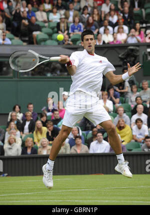 Serbia's Novak Djokovic in action against France's Julien Benneteau during the 2009 Wimbledon Championships at the All England Lawn Tennis and Croquet Club, Wimbledon, London. Stock Photo