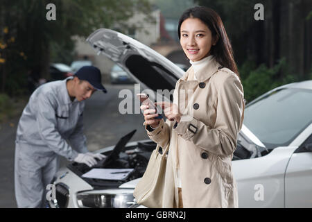 The young woman and the auto repairman Stock Photo