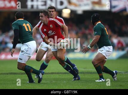 British and Irish Lions' Jamie Roberts (back) looks on as team mate Lee Byrne attempts to offload before being tackled by South Africa's Adrian Jacobs (right) and SBryan Habana (left) Stock Photo