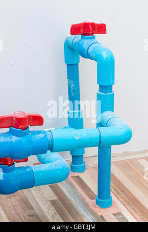 Red plastic valve on the PVC pipe for control the water tank. Stock Photo