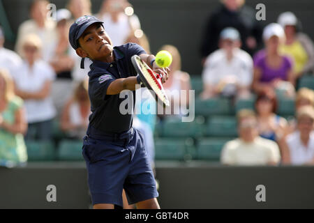 A ball boy plays on court one after France's Michael Llodra retires through injury during his match against Germany's Tommy Haas Stock Photo