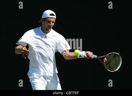 France's Paul-Henri Mathieu in action against Portugal's Frederico Gil during the 2009 Wimbledon Championships at the All England Lawn Tennis and Croquet Club, Wimbledon, London. Stock Photo