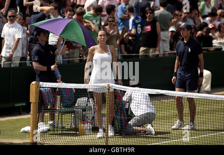 Serbia's Jelena Jankovic receives treatment from a physio during her match against USA's Melanie Oudin during the 2009 Wimbledon Championships at the All England Lawn Tennis and Croquet Club, Wimbledon, London. Stock Photo