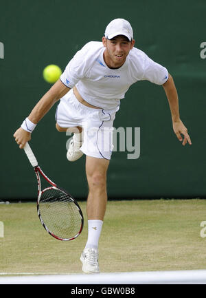 Israel's Dudi Sela in action against Serbia's Novak Djokovic during the Wimbledon Championships at the All England Lawn Tennis and Croquet Club, Wimbledon, London. Stock Photo