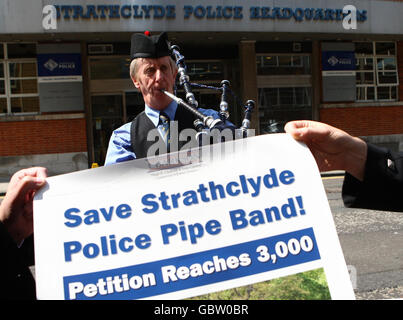 Piper Willie Park plays as a petition is presented to the Chief Constable of Strathclyde Police voicing concern over planned cuts to the force's pipe band in Glasgow.