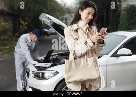 The young woman and the auto repairman Stock Photo
