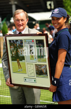 Ball Girl Chloe Chambers is presented with signed picture by All England Club Committee Member Julien Tatum, after she played tennis with Tommy Haas during the 2009 Wimbledon Championships at the All England Lawn Tennis and Croquet Club, Wimbledon, London. Stock Photo