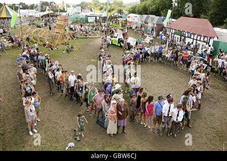 Festival goers form a 'human no' on the Greenpeace field in protest against the government's plans for airport expansion during the 2009 Glastonbury Festival at Worthy Farm in Pilton, Somerset. Stock Photo