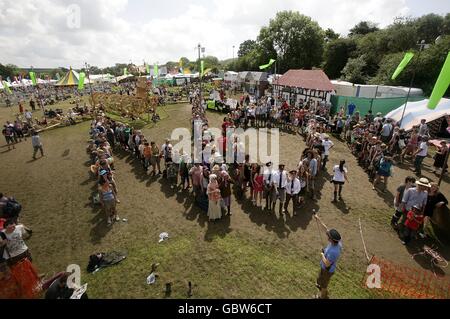 Festival goers form a 'human no' on the Greenpeace field in protest against the government's plans for airport expansion during the 2009 Glastonbury Festival at Worthy Farm in Pilton, Somerset. Stock Photo