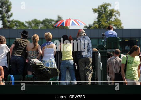 Spectators watch the action during day seven of the 2009 Wimbledon Championships at the All England Lawn Tennis and Croquet Club, Wimbledon, London. Stock Photo