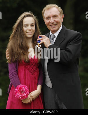 Sir Thomas Farmer, Chairman of the Board of Trustees, for The Duke of Edinburgh Awards, after he was made a member of the Royal Victorian Order by Queen Elizabeth II, accompanied by his granddaughter Emma Swycher, 16, at the Palace of Holyrood House, Edinburgh, Scotland. Stock Photo