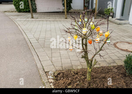 Tree with coloured easter eggs in spring Stock Photo