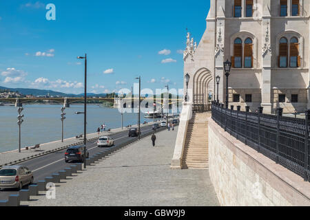 View along Antall József road at Parliament building, looking towards Margaret Bridge and Danube river, Budapest, Hungary Stock Photo