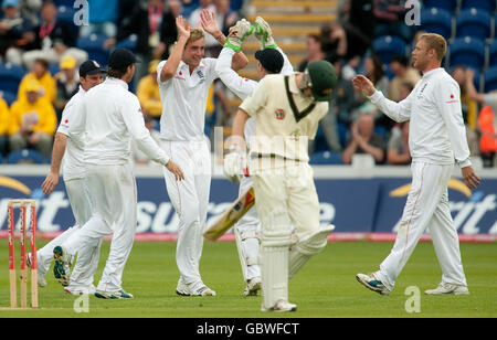 England's Stuart Broad (centre, left) celebrates with teammates after dismissing Australia's Michael Clarke during day three of the first npower Test match at Sophia Gardens, Cardiff. Stock Photo