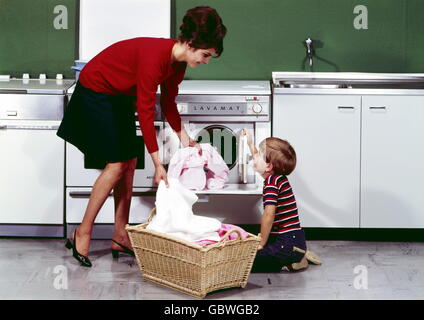 Doing the laundry in the 1960s. A lady is using a washboard to