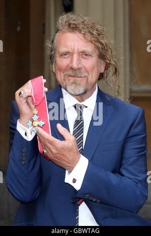 Former Led Zeppelin frontman Robert Plant with his CBE which he received from the Prince of Wales during the investiture ceremony at Buckingham Palace. Stock Photo