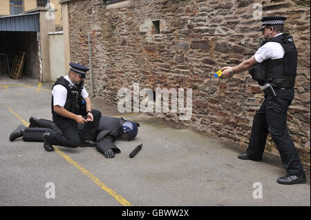 Police officers train using their Taser X26 fitted with blue training cartriges that don't deliver an electric shock Stock Photo