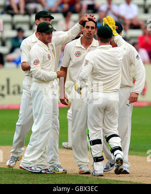 Australia's Mitchell Johnson is congratulated after bowling England Lions' Tim Bresnan during the International Tour match at New Road, Worcester. Stock Photo