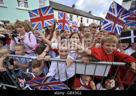 Children from Lostwithiel Town School and St Winnow School, wave flags, during a visit to Lostwithiel, Cornwall, by the Prince of Wales and the Duchess of Cornwall. Stock Photo