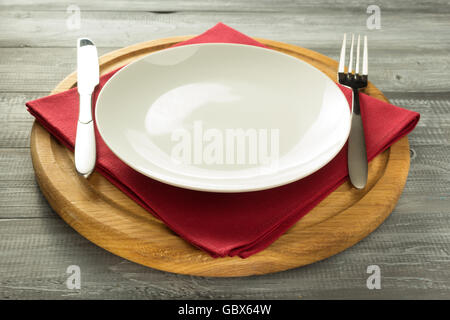 plate, knife and fork on rustic wooden background Stock Photo