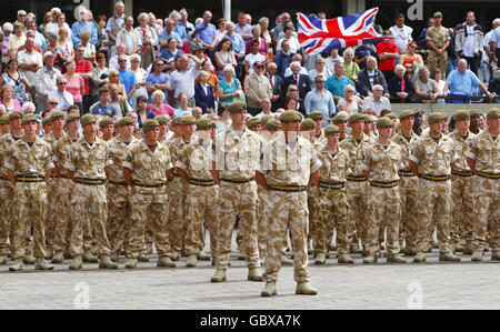 A large crowd looks on as 200 soldiers from the Princess of Wales' Royal Regiment parade in Guildhall Square Portsmouth, following tours of Afghanistan and Iraq. Stock Photo