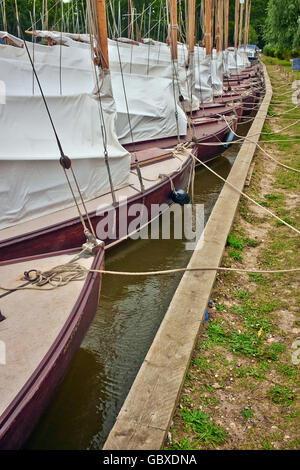 Classic Norfolk Broads Sailing Yachts Moored Up In The Norfolk Broads, England UK Stock Photo