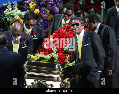 Michael Jackson's brothers (L-R) Randy, Marlon, Tito, Jermaine, and Jackie carry his casket out of the Staples Center following memorial services for pop star Michael Jackson. Stock Photo