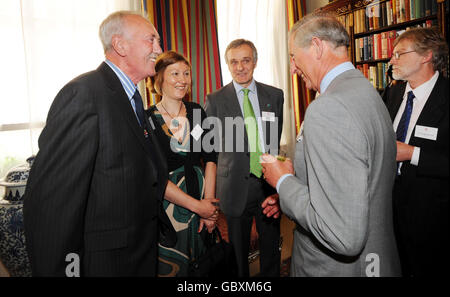 The Prince of Wales (second right), talks with (from left to right) former fisherman and current Chief Executive of the North Devon Fisherman's Association, John Butterwith, Estelle Brennan of Lyons Seafood and John Arnold of the Fairtrade Foundation at a reception at Clarence House to mark the 10th anniversary of the Marine Stewardship Council. Stock Photo